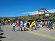 A thumb nail view of Grand Lake, Colorado during Constitution Week in September looking at our Veterans carrying flags as they march in the parade; click here to open a window with a larger picture.